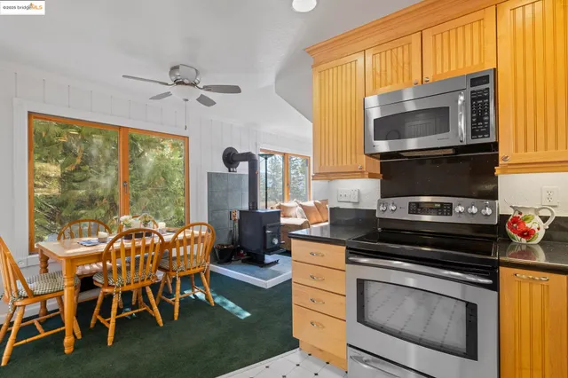 a kitchen with granite countertop a refrigerator a sink a stove a washer and dryer