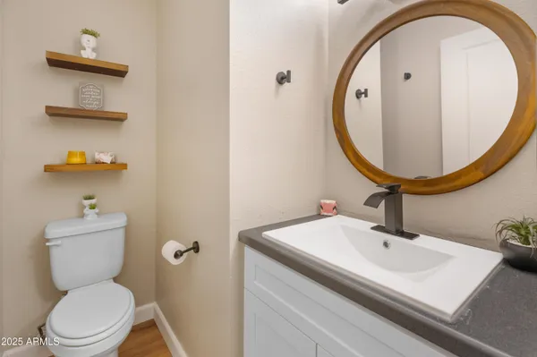 a bathroom with a sink a mirror and toilet