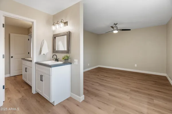 a bathroom with a sink vanity and a mirror