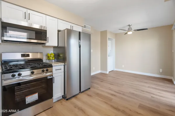 a kitchen with stainless steel appliances a stove a microwave and cabinets
