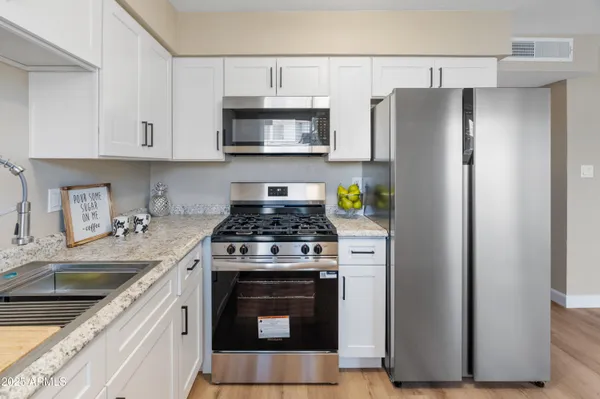 a kitchen with a stove and a refrigerator