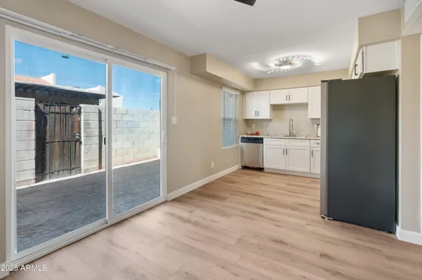 a view of kitchen with refrigerator and window