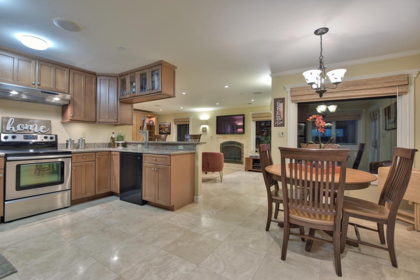 18610 Decatur Road Los Gatos, CA 95030 - Photo 38 of 48 a kitchen with a table chairs microwave and cabinets