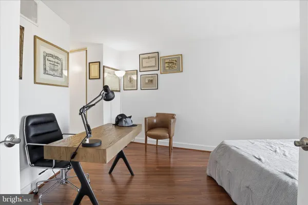 a view of a workspace with furniture and wooden floor