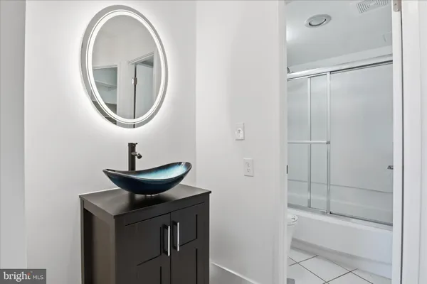 a bathroom with a sink a mirror and a shower