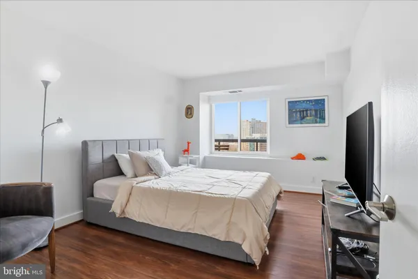 a bedroom with a bed and a flat screen tv