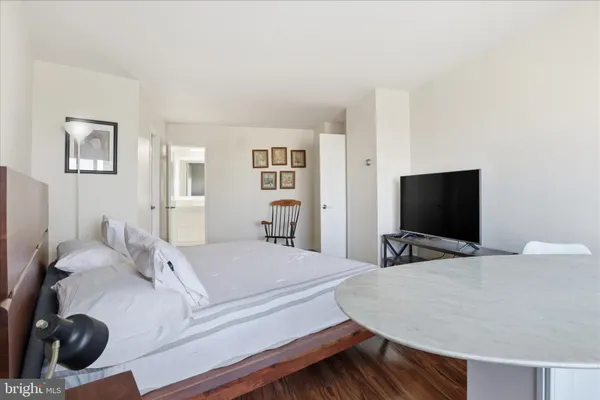a bedroom with a bed and a flat screen tv