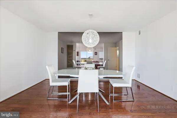 a view of a dining room with furniture and wooden floor