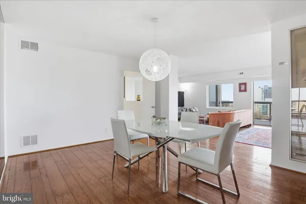 a view of a dining room with furniture and wooden floor