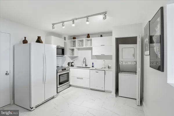 a kitchen with stainless steel appliances a refrigerator sink and cabinets