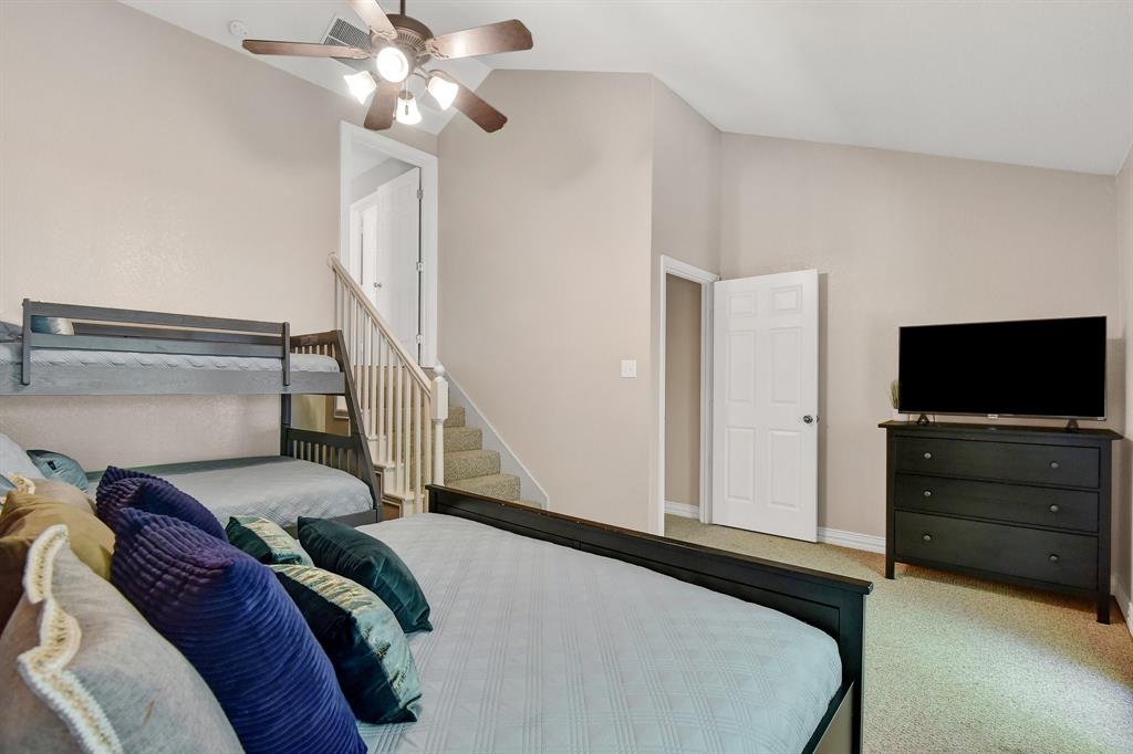 766 Lakepoint Loop Pottsboro, TX 75076 - Photo 21 of 33 a bedroom with a bed and a flat screen tv