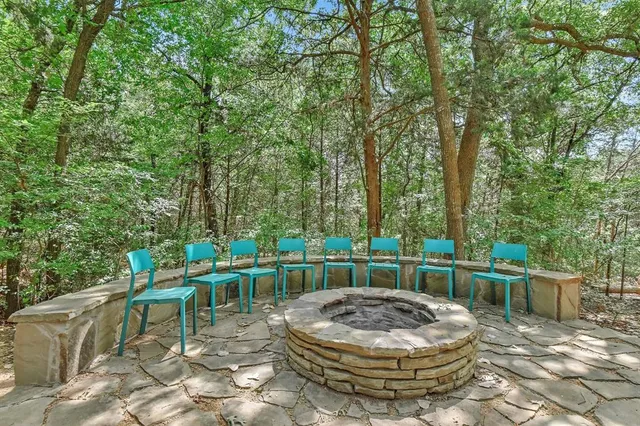 a view of a chairs and table in the back yard