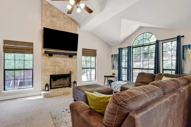 a living room with furniture a flat screen tv and a fireplace