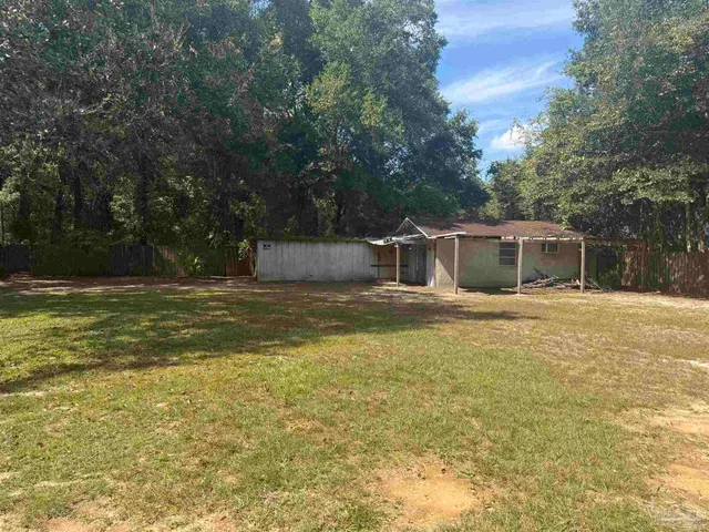 a house view with swimming pool in front of it