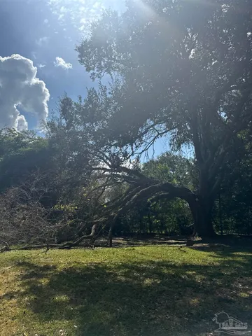 a backyard of a house with a yard and outdoor seating