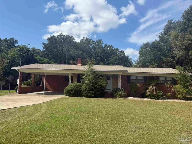 a view of house with yard and entertaining space