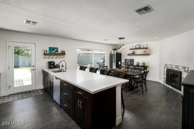 a large kitchen with kitchen island a sink table and chairs