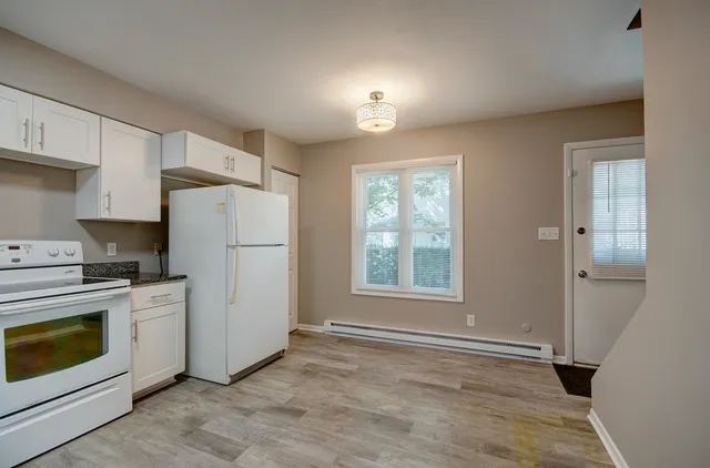 a view of a kitchen with a stove cabinets and a refrigerator