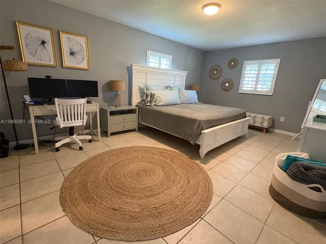 a bedroom with bed and window