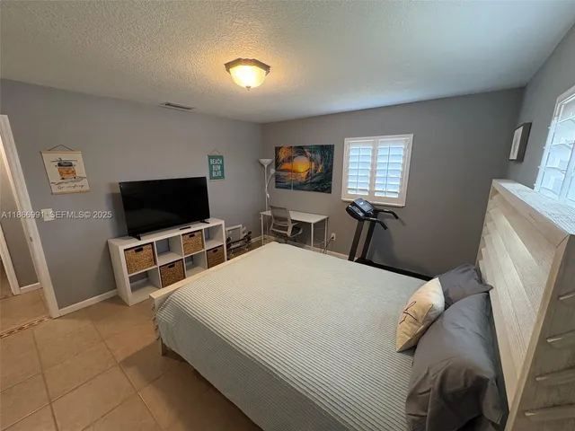 a bedroom with a bed and a mirror