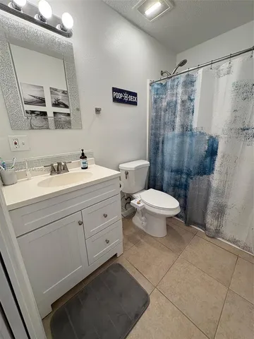 a bathroom with a shower toilet and sink