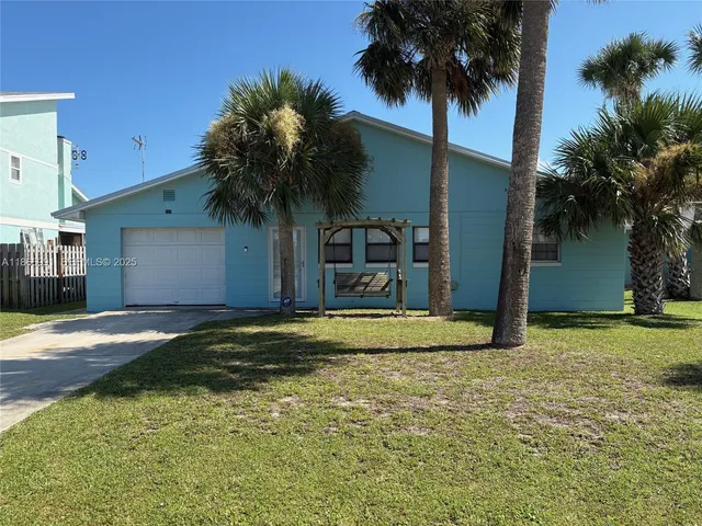 a house with palm tree in front of it