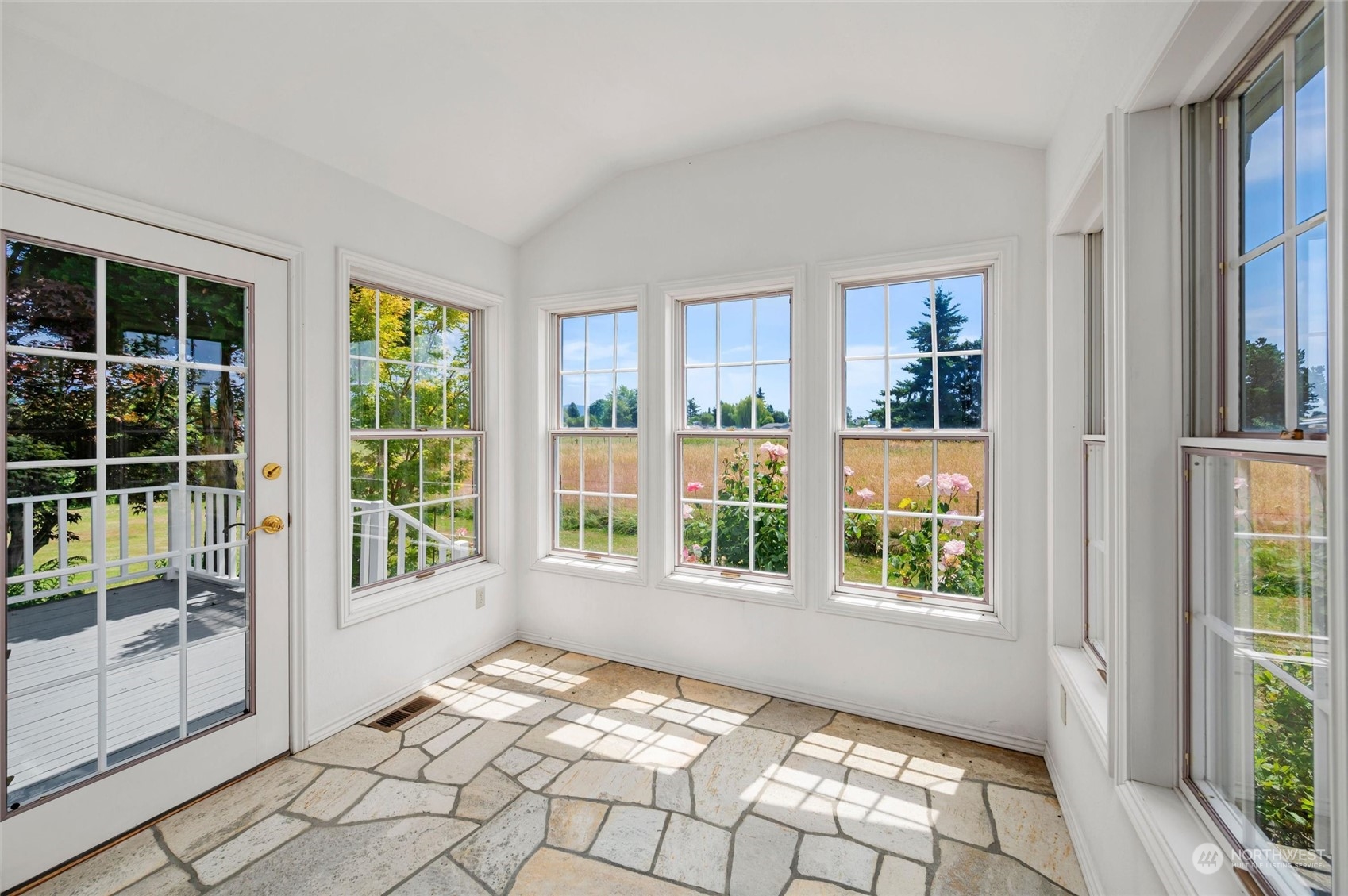 13595 Avon Allen Road Mount Vernon, WA 98273 - Photo 11 of 37 a view of an empty room with windows and wooden floor