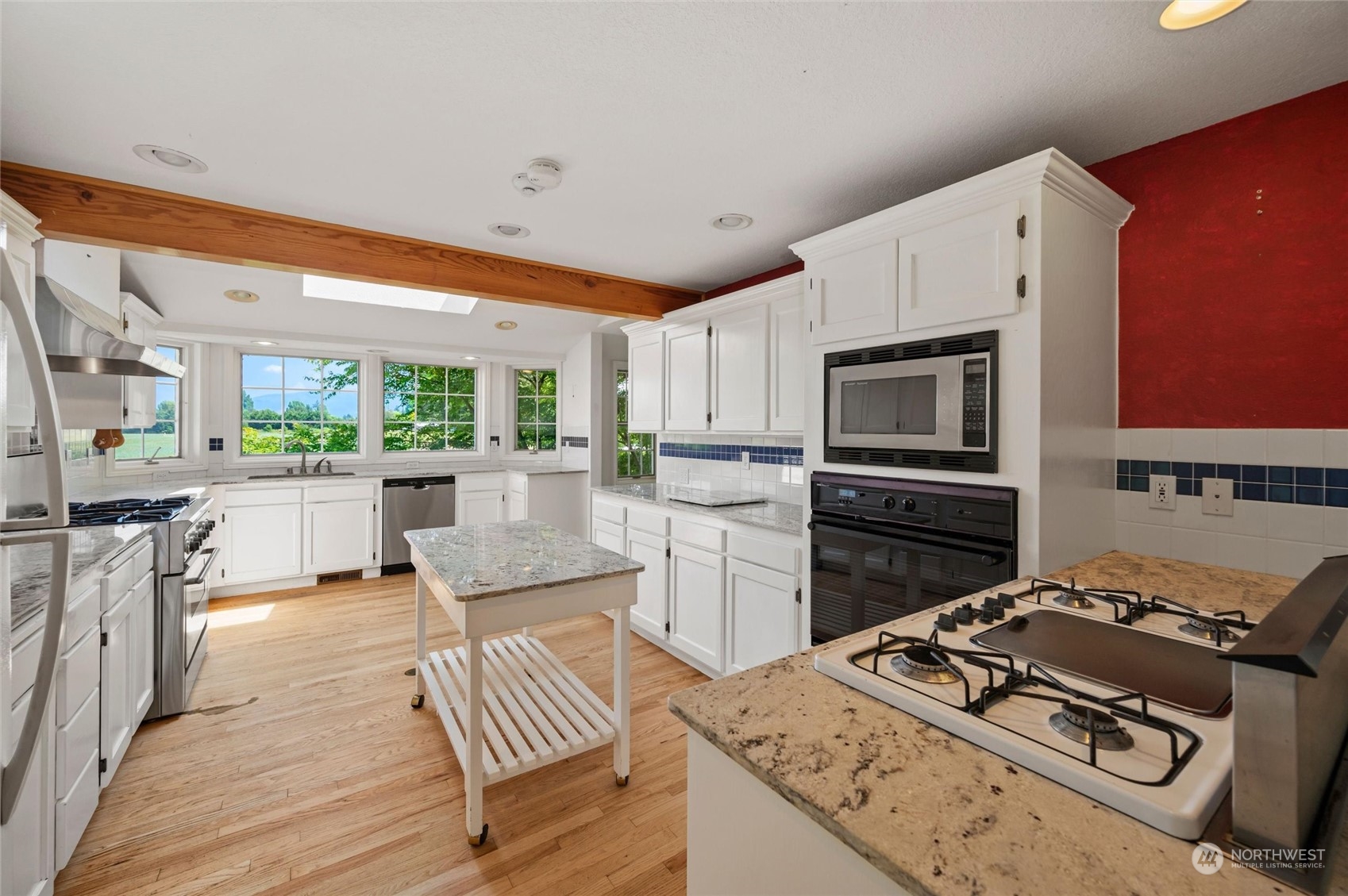 13595 Avon Allen Road Mount Vernon, WA 98273 - Photo 12 of 37 a kitchen with a stove a sink and a microwave