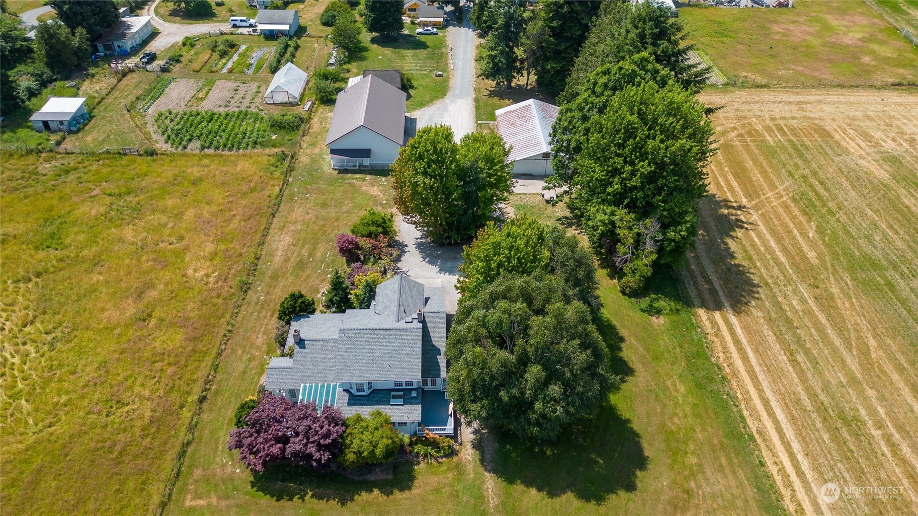 13595 Avon Allen Road Mount Vernon, WA 98273 - Photo 4 of 37 an aerial view of residential house with swimming pool and lawn chairs
