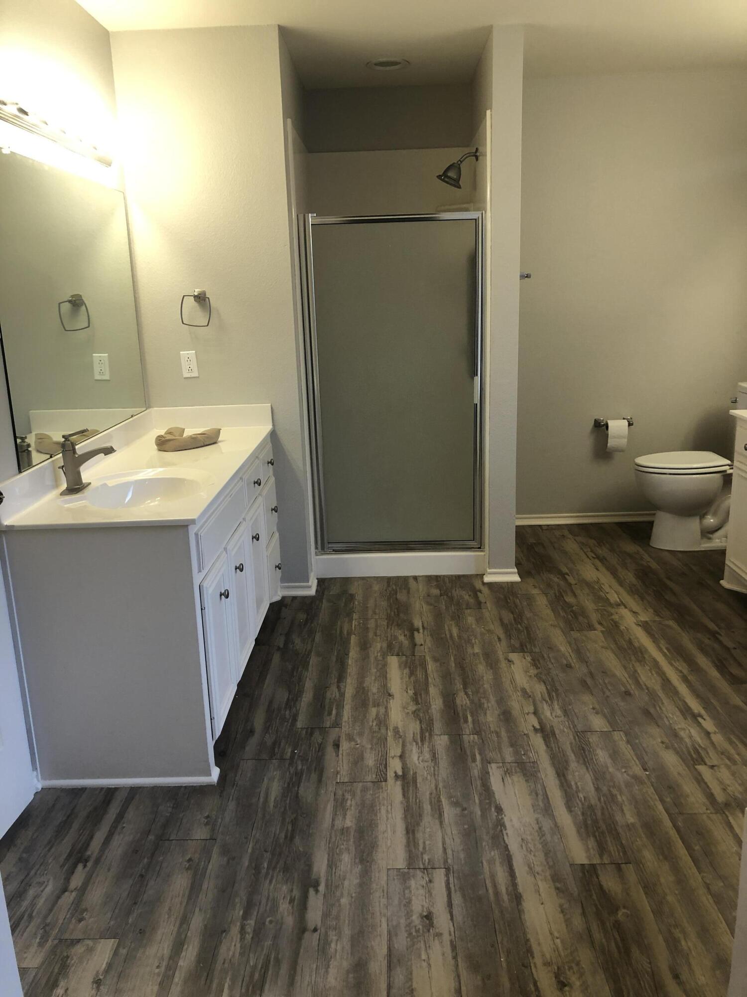 7528 84th Street Lubbock, TX 79424 - Photo 15 of 20 a bathroom with a sink and a mirror