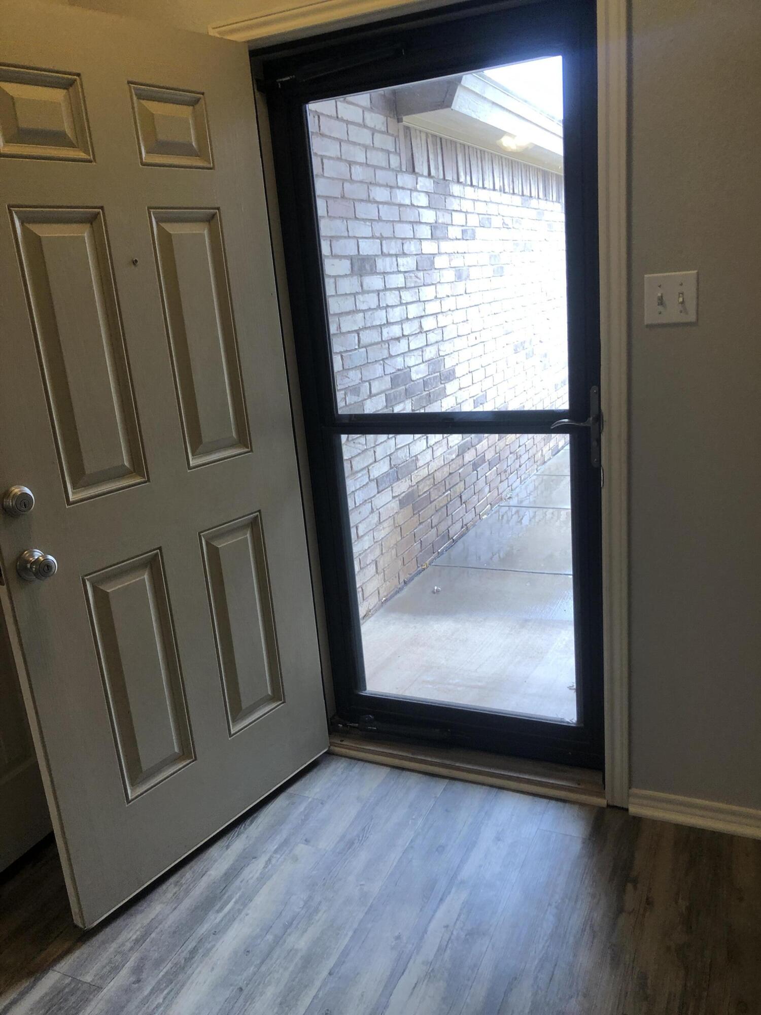 7528 84th Street Lubbock, TX 79424 - Photo 18 of 20 a view of front door with wooden floor