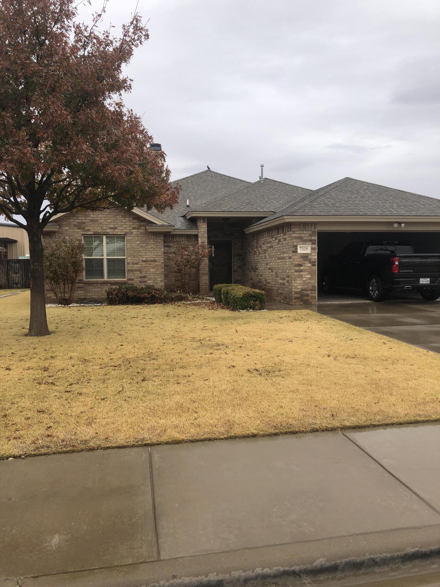 7528 84th Street Lubbock, TX 79424 - Photo 2 of 20 a swimming pool with trees in front of it