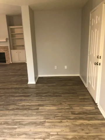 a view of a room with wooden floor and staircase