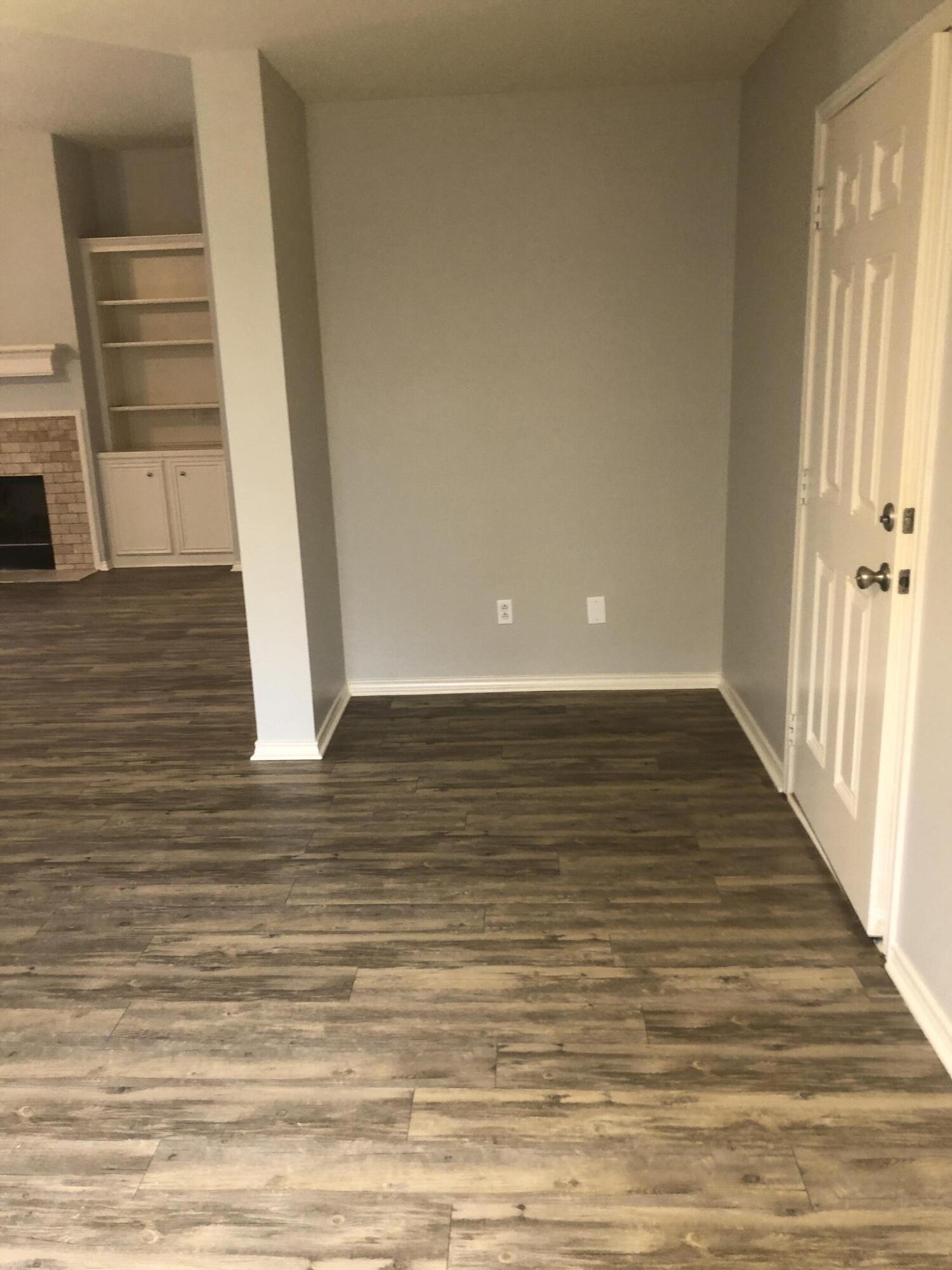 7528 84th Street Lubbock, TX 79424 - Photo 9 of 20 a view of a room with wooden floor and staircase