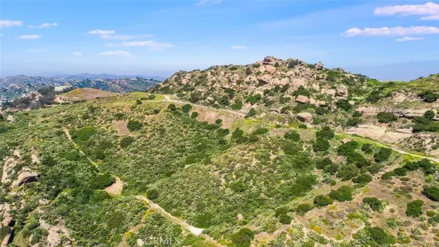 a view of a large building with mountains in the background