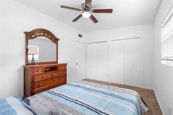 a bedroom with a bed and a dresser