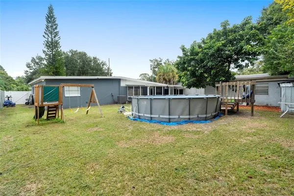 a view of a house with backyard and sitting area