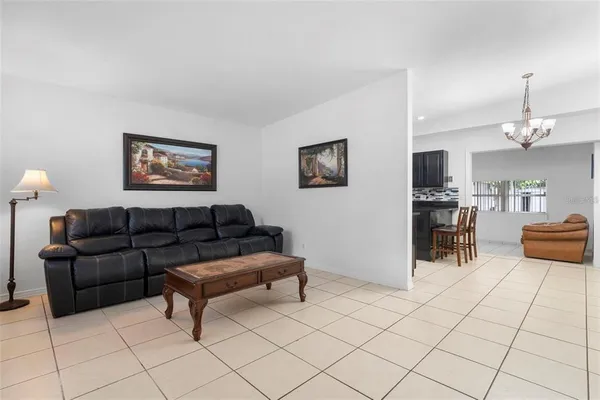 a living room with furniture and a chandelier
