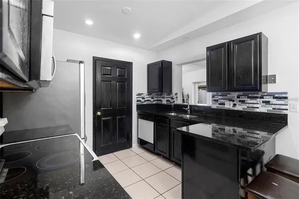a kitchen with a sink stove and refrigerator