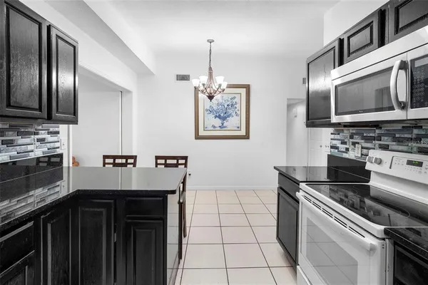 a kitchen with a stove and a microwave