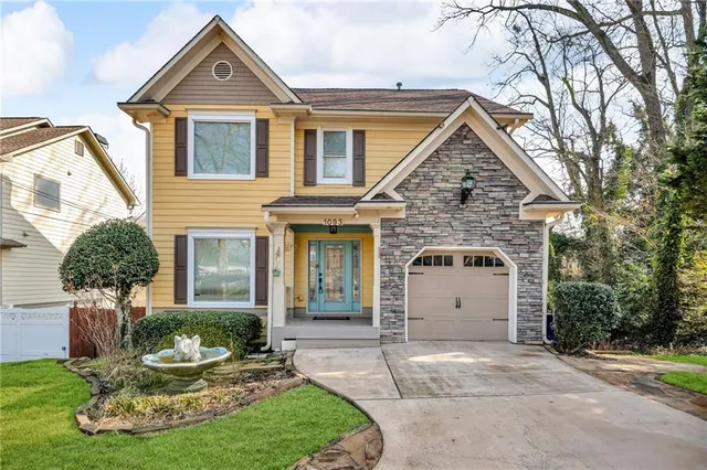 a front view of a house with a yard and garage