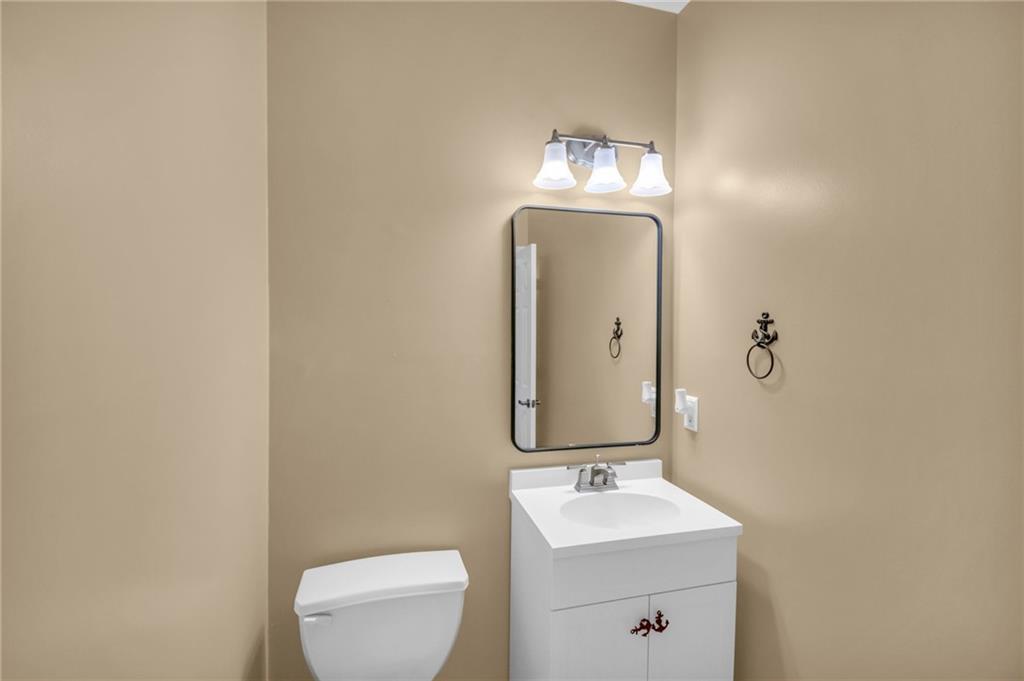 1093 3rd Street Stone Mountain, GA 30083 - Photo 13 of 43 a bathroom with a toilet sink and mirror