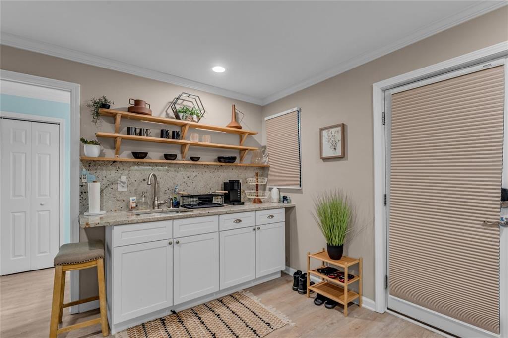 1093 3rd Street Stone Mountain, GA 30083 - Photo 26 of 43 a kitchen with a cabinets and chairs in it