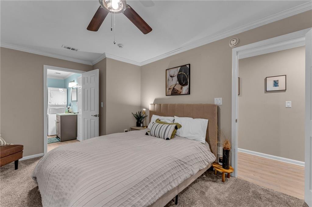 1093 3rd Street Stone Mountain, GA 30083 - Photo 34 of 43 a bedroom with a large bed and a chandelier