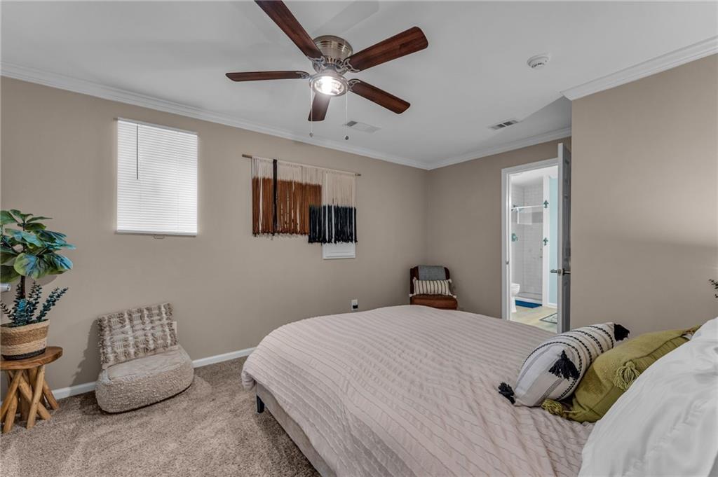 1093 3rd Street Stone Mountain, GA 30083 - Photo 35 of 43 a bedroom with a bed and a potted plant