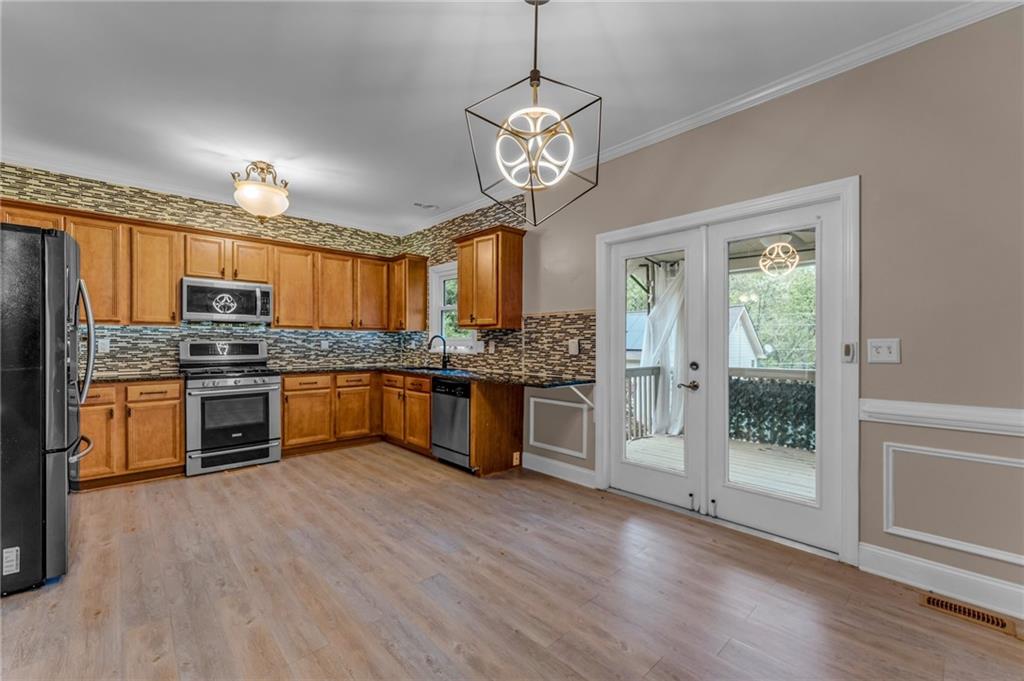 1093 3rd Street Stone Mountain, GA 30083 - Photo 7 of 43 a kitchen with stainless steel appliances granite countertop a stove refrigerator and cabinets
