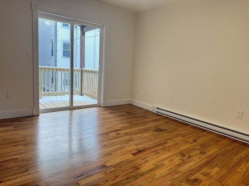 13 Murray Court, Unit 1 Boston, MA 02128 - Photo 15 of 22 wooden floor in an empty room with a window