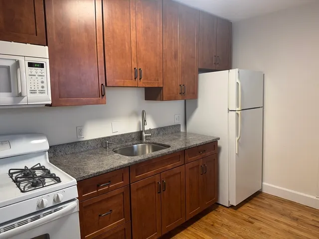 a kitchen with cabinets appliances and a sink