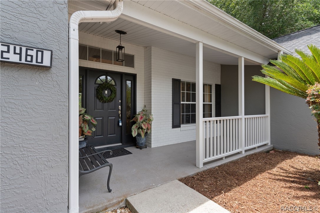 2460 West Pine Ridge Boulevard Beverly Hills, FL 34465 - Photo 4 of 47 a view of a house with a porch
