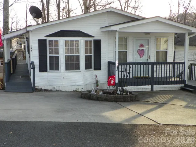 a view of a house with a small yard and wooden fence
